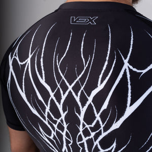 Close-up of the ABYSS SERIES rash guard back print and VEX logo