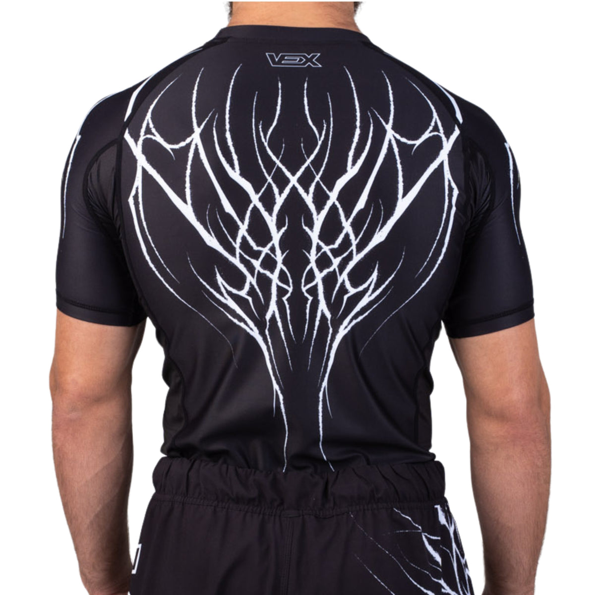 ABYSS SERIES rash guard worn by a model, back view
