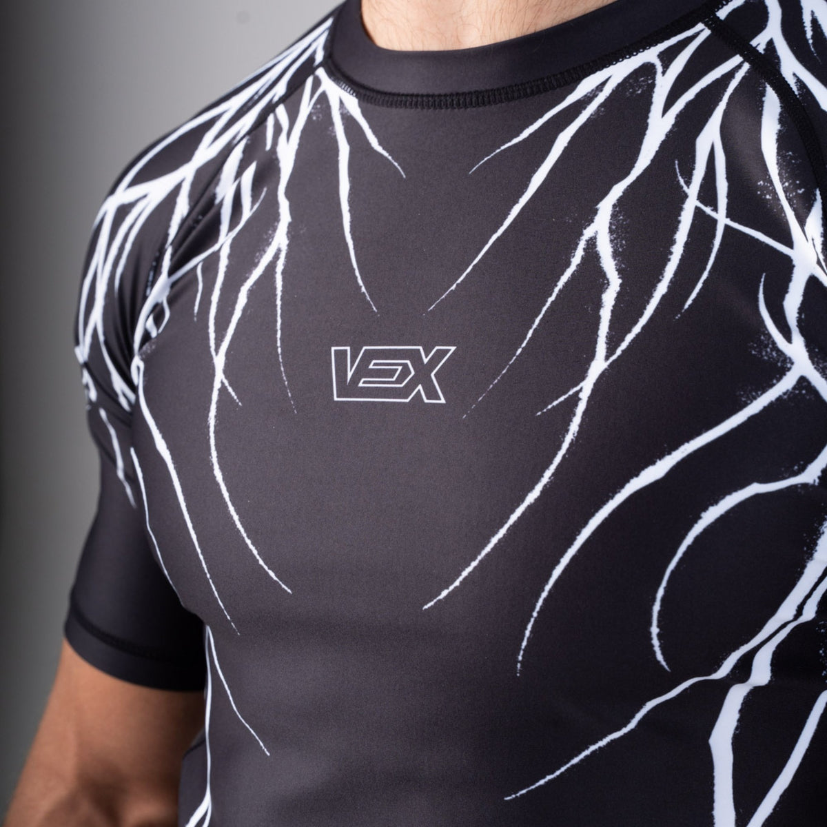 Close-up of the ABYSS SERIES rash guard chest print and VEX logo